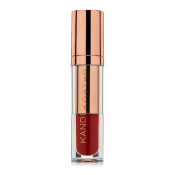 A closed clear and rose gold tube of Liquid Satin lip shine in “True Love”, a dark rich blood red. The tube has Kandi Koated written up the side in rose gold letters and a rose gold cap.